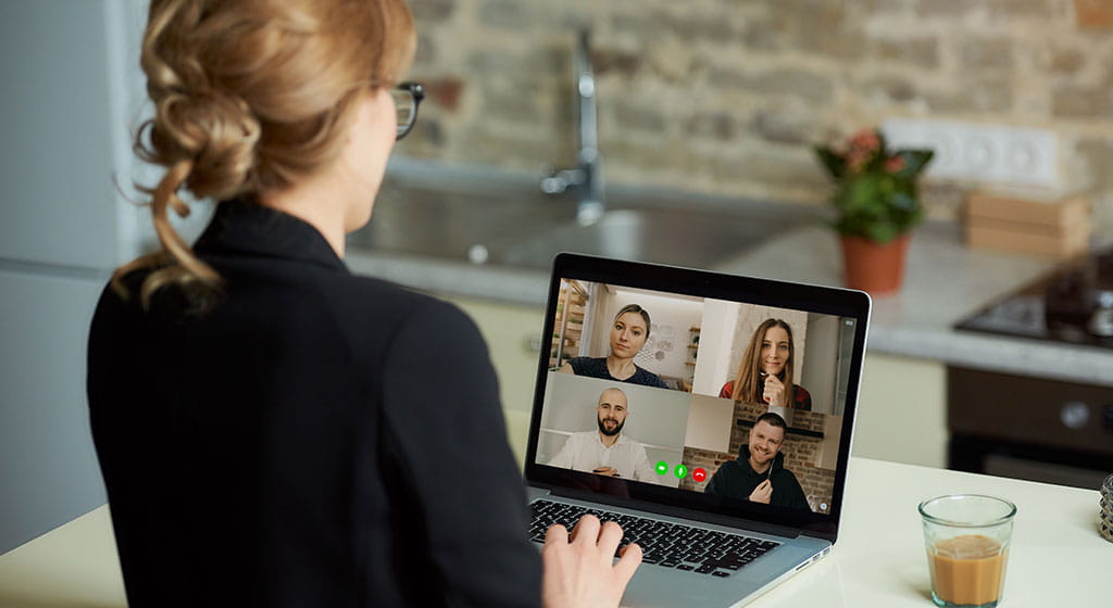 Woman with laptop attending a virtual meetup